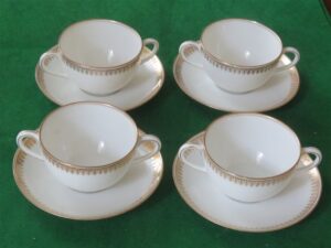 Flat Bouillon Cup & Saucer by Charles Ahrenfeldt. Made for the Cromwell And Hubbard of Cleveland One set of 4 cups and saucers. 1